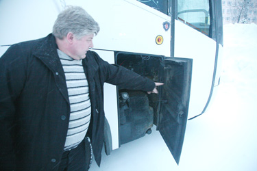 Bussiettevõtja Jüri Saar näitab kütusepaagi juures olevat luuki, kus on seniajani näha kütuse oskamatust väljapumpamisest jäänud jäljed.  Foto: Võrumaa Teataja