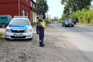 Võru politseiosakonna välijuht Maikl Uibo (esiplaanil) ja patrullpolitseinik Erko Sibul on koha sisse võtnud Tartu tänava ääres. Foto: INNO TÄHISMAA