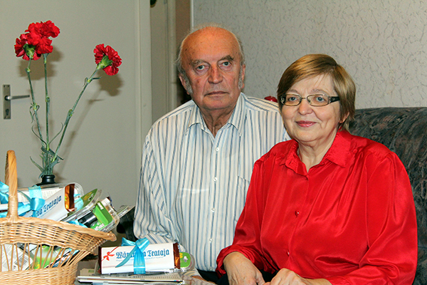 Ülle ja Leiger isadepäevaks saadud nelkide juures. Paari ees on korv, kust nad endale loosiauhinna välja said tõmmata. Igas pakis leidub miskit, mis pimedatel õhtutel abiks on ning peale selle veel Klicki poe kinkekaart. Korvis on peale kümneeuroste kaartide peidus ka 30eurone kinkekaart.  Foto: AIGAR NAGEL