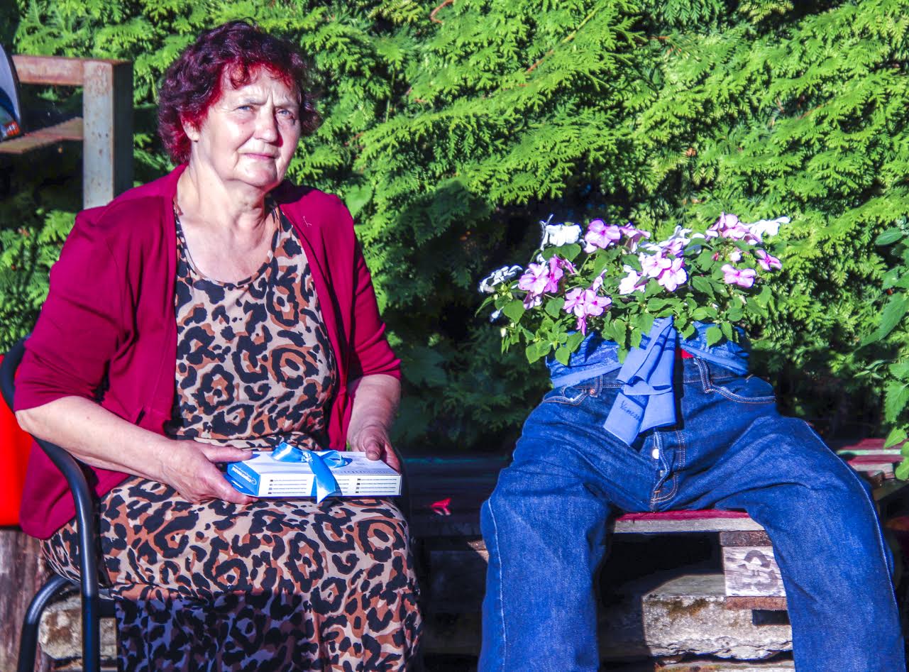 Evi koos „kavaleriga“, nagu ta oma seadeid hellitavalt kutsub, koduaias istumas. Süles tellijaauhind, milleks sel nädalal on akupank digipood.eu’lt ja 50eurone Kagukeskuse kinkekaart. Foto: AIGAR NAGEL