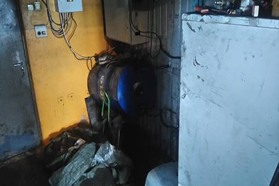 Pildil on küttesüsteem, mille puhul kahtlustatakse vanaõliga kütmist. Vasakul pool kütusepaak (sinise otsaga), paremal katel.